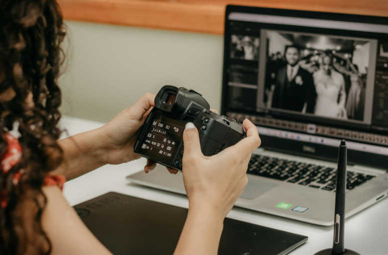 Wedding Photographer checking camera and culling photos