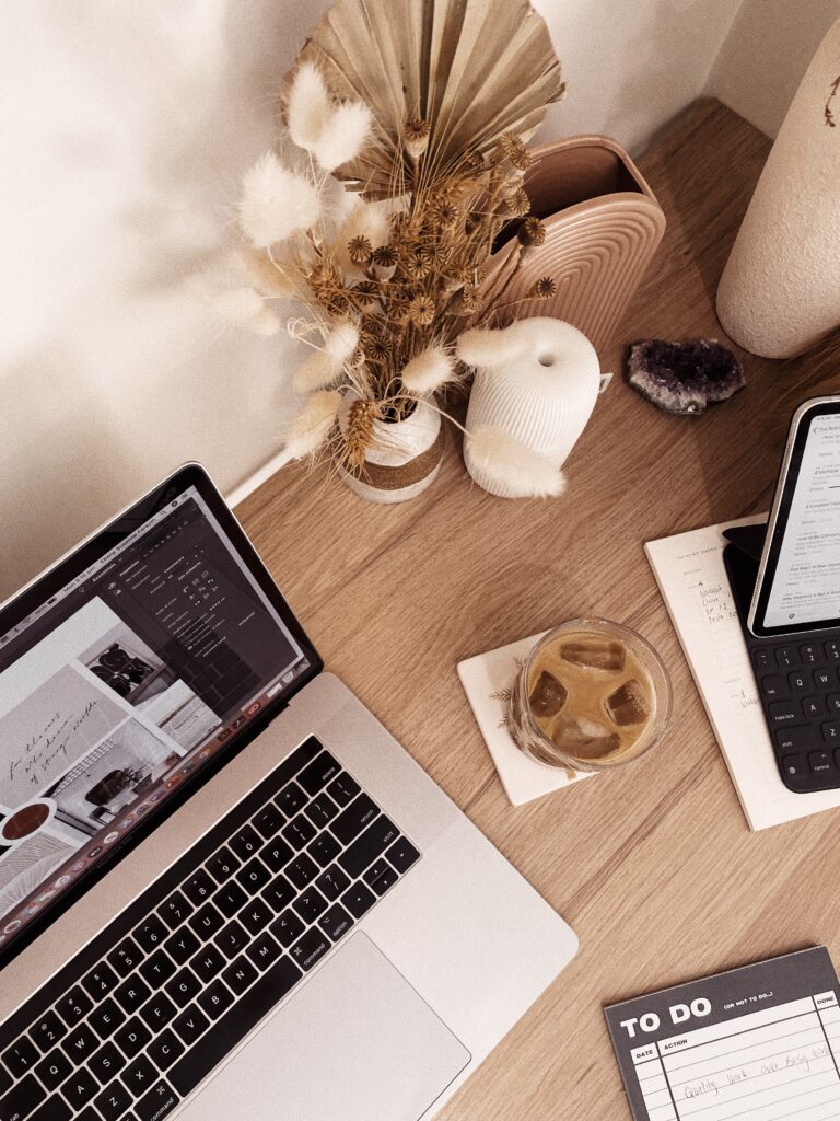 Laptop, iced coffee, and to-do list representing the small admin tasks that quietly steal time for your workday